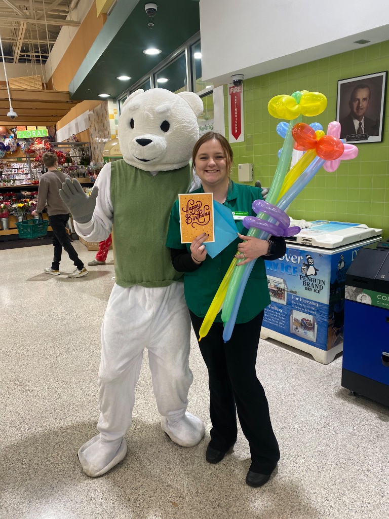 Polar bear mascot and balloon twister at community event