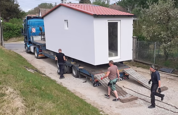 Modulház telepítése helyszínen kamionról leemelve szakemberekkel