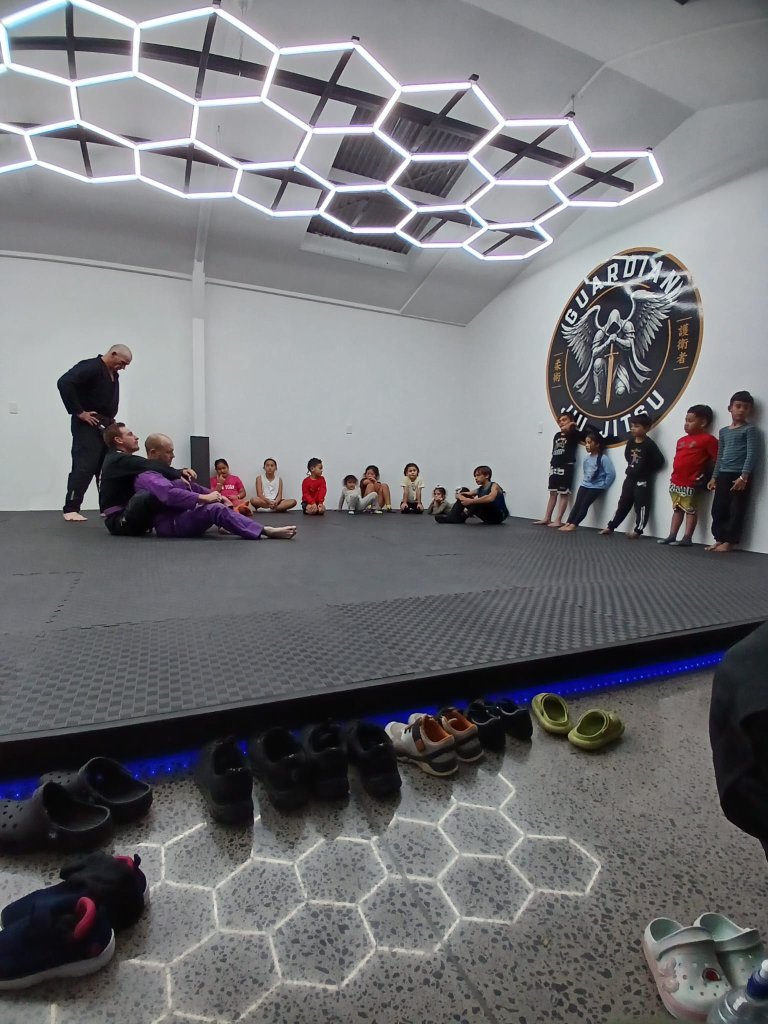 Instructor demonstrating a technique during a kids class at Guardian Jiu Jitsu