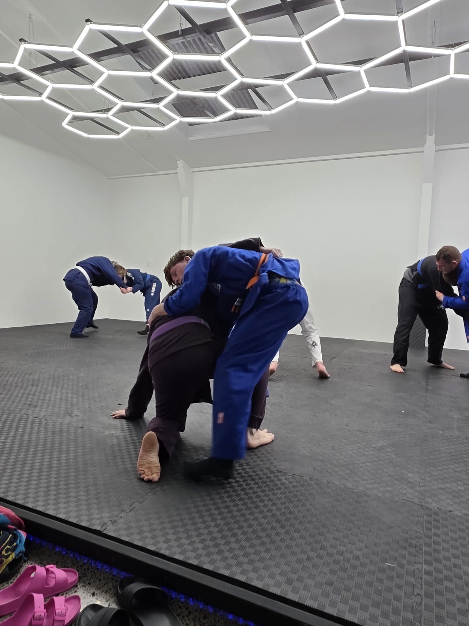 Students grappling in gi during a Guardian Jiu-Jitsu class