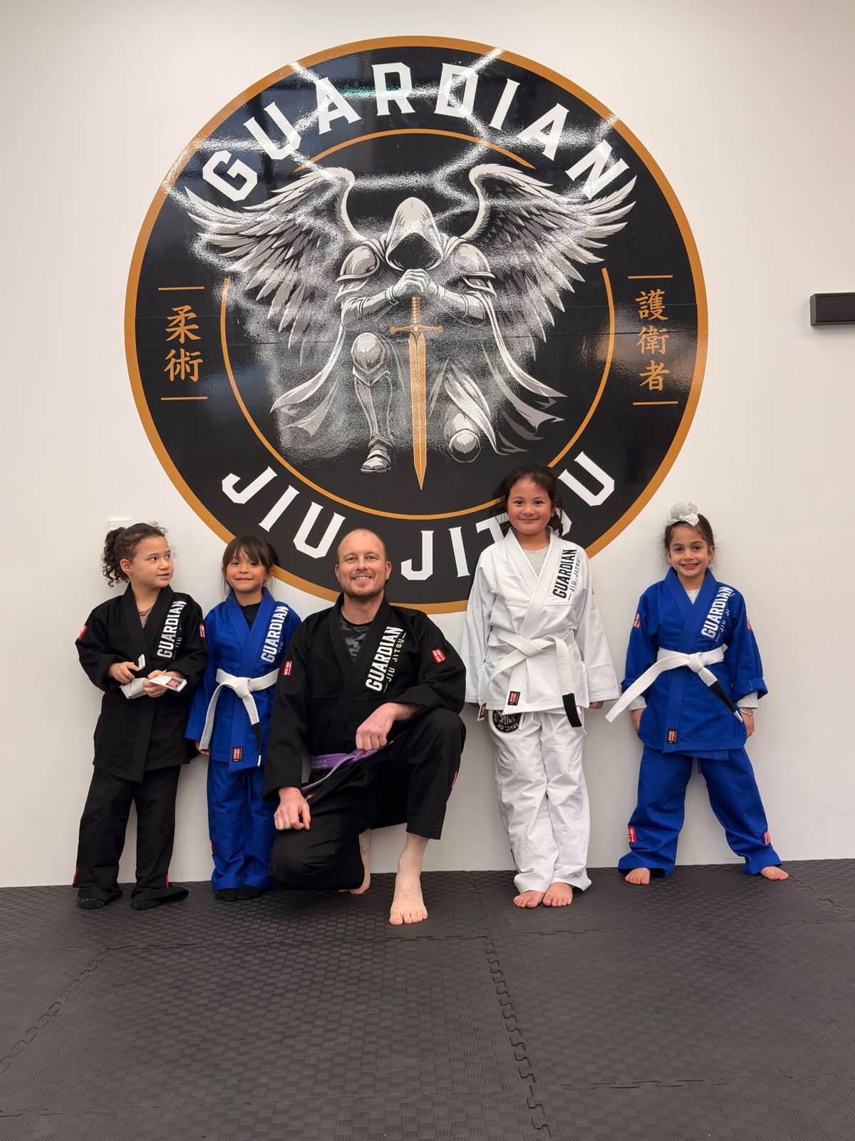 Coach Jay with kids class students at Guardian Jiu-Jitsu
