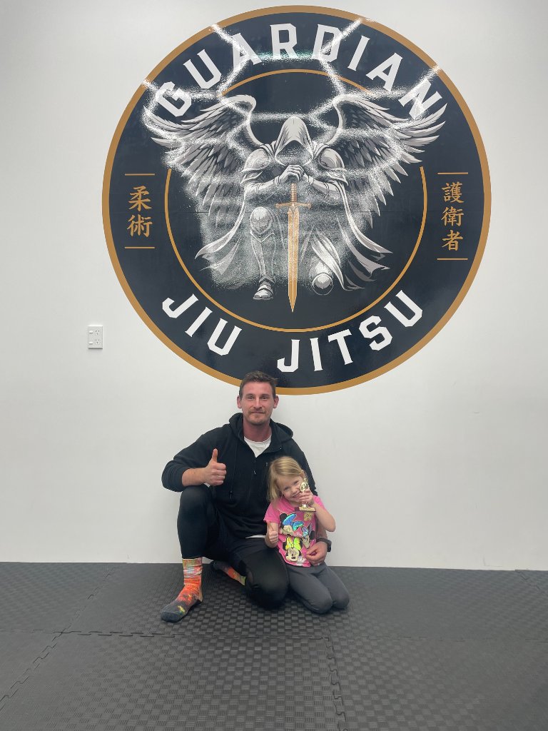 Coach Alex with a student at the Guardian Jiu Jitsu academy
