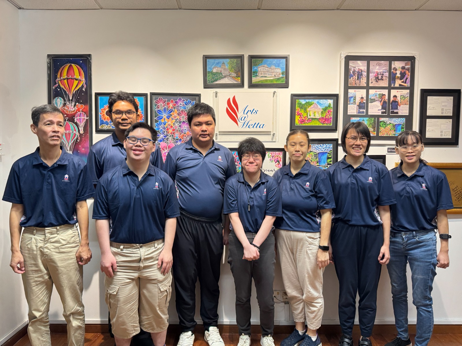 Arts@Metta artists in front of their work
