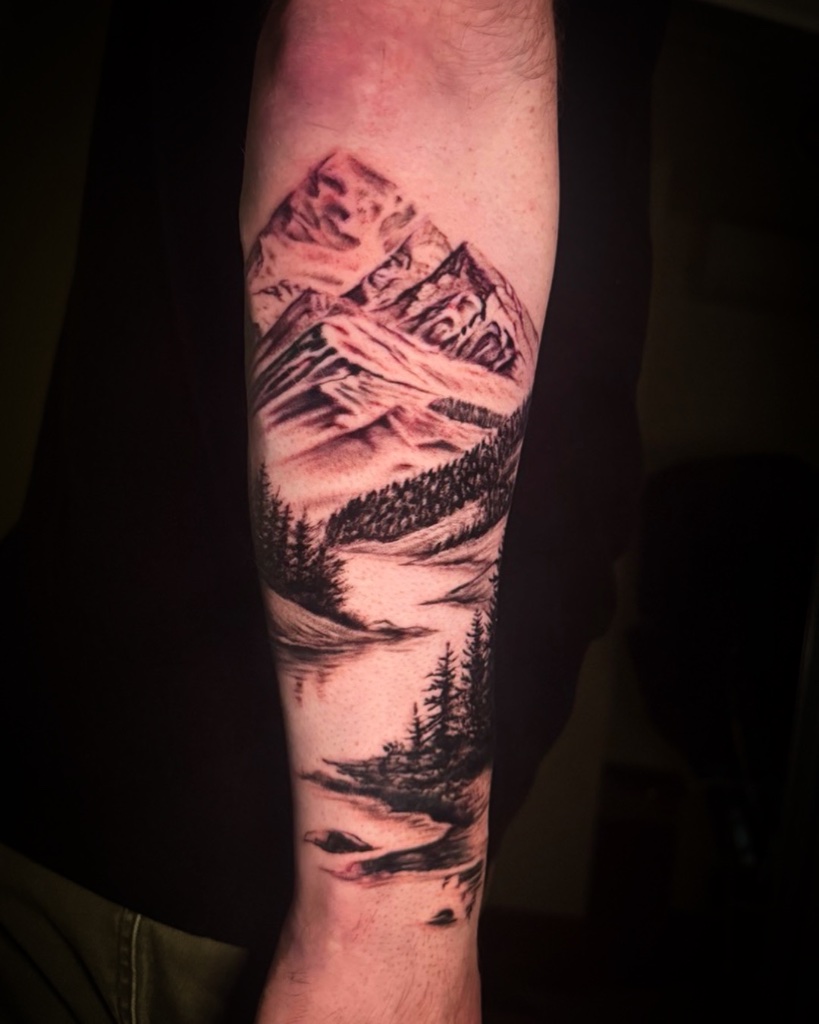 Mountain landscape black and grey forearm tattoo by V01 Ink