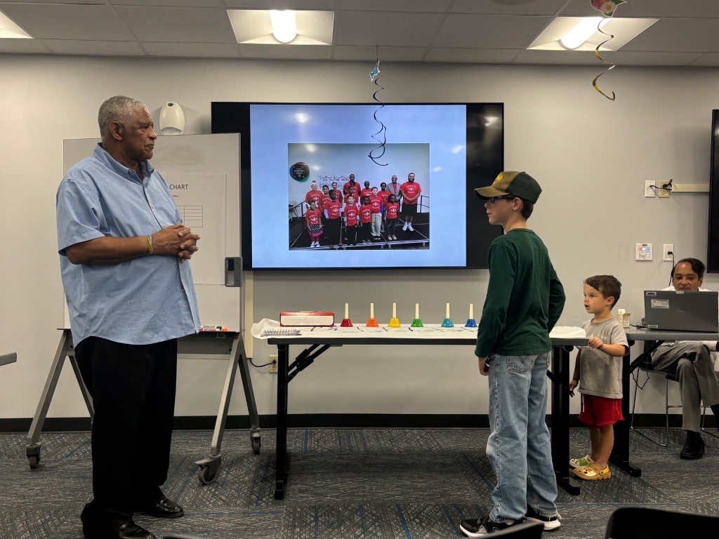 Mentor speaking with students at a music event