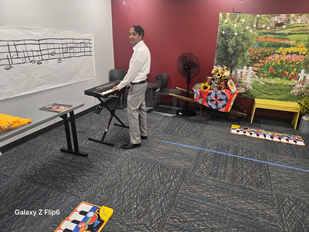 Mentor playing keyboard in the music studio