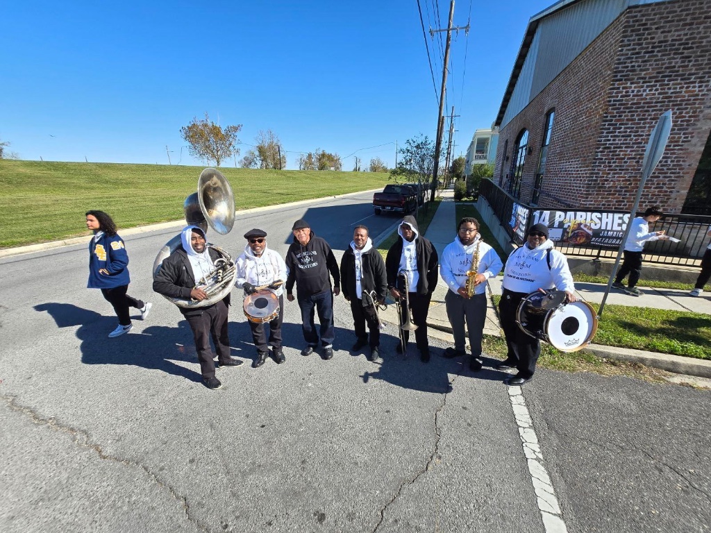 Brass band members marching in the community