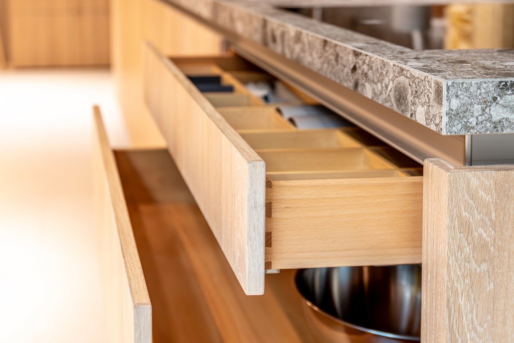 Custom kitchen cabinetry with dovetail joinery and wooden drawer dividers