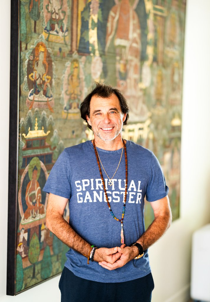 Ian Lopatin standing near spiritual artwork