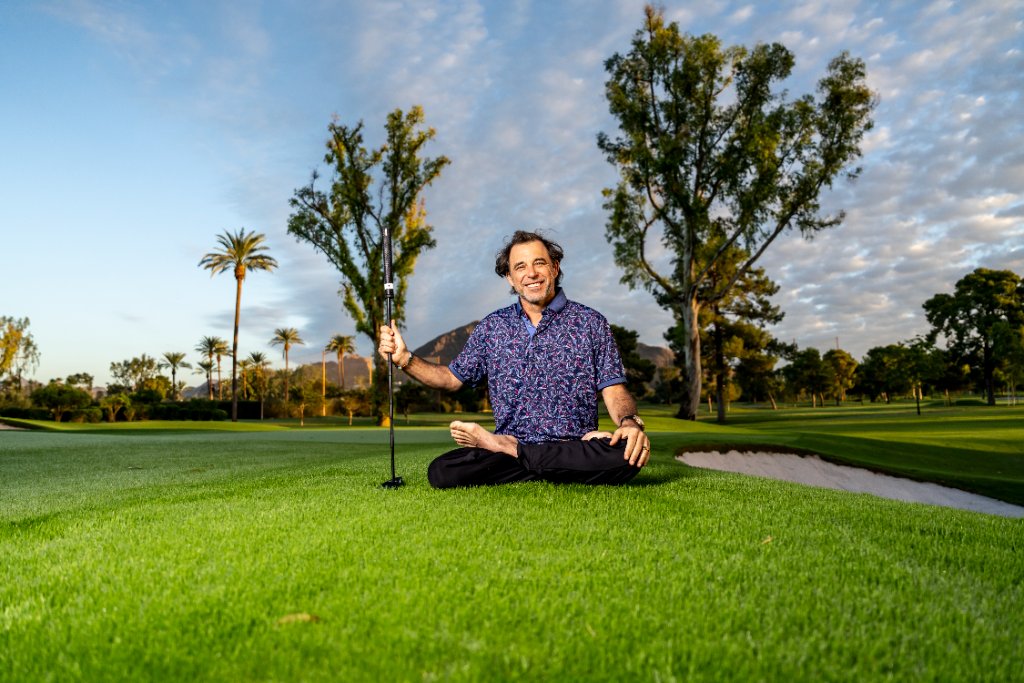 Ian Lopatin meditating outdoors on a golf course