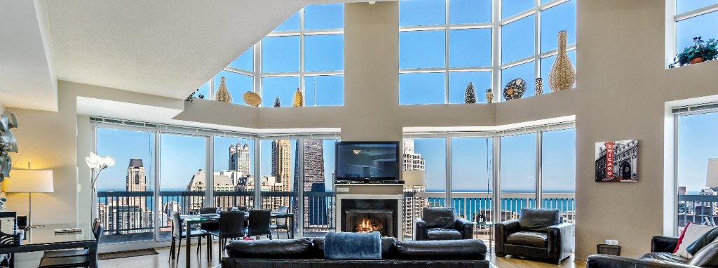 Chicago penthouse living room with skyline and lake views