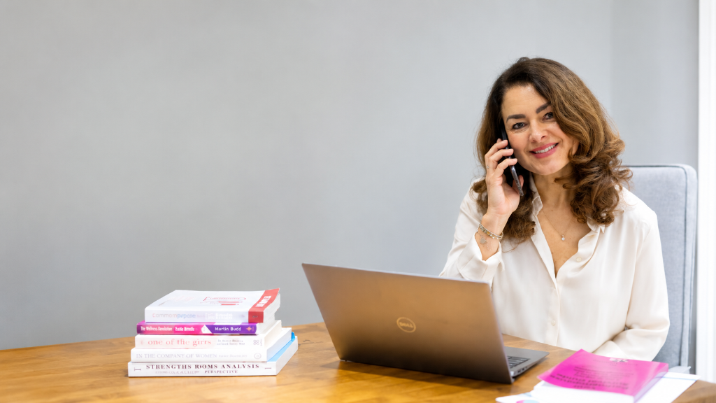Lucy Childerley at her desk, taking a call