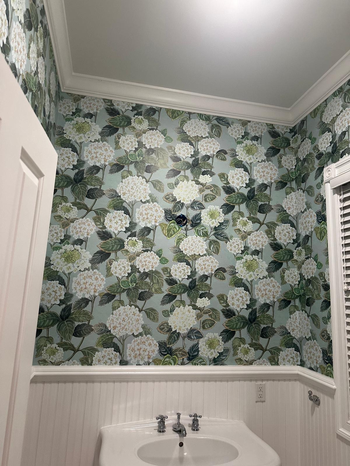 Hydrangea wallpaper in a powder room with beadboard