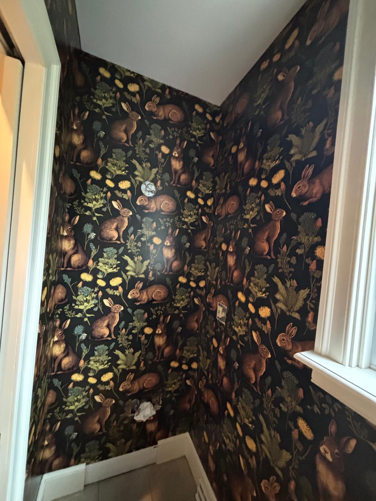 Rabbit wallpaper in a small bathroom corner
