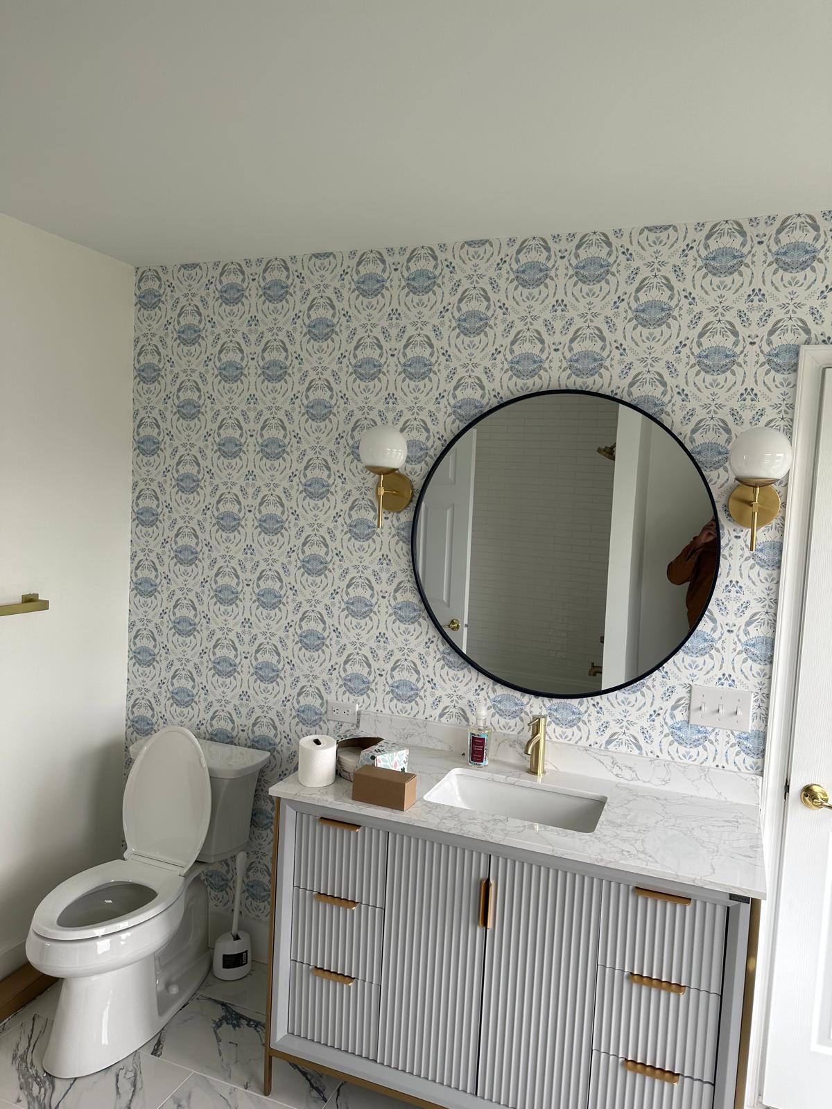 Crab pattern wallpaper behind a bathroom vanity