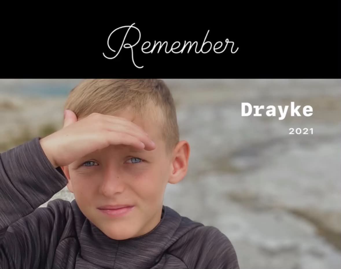 Drayke shading his eyes and smiling, 2021