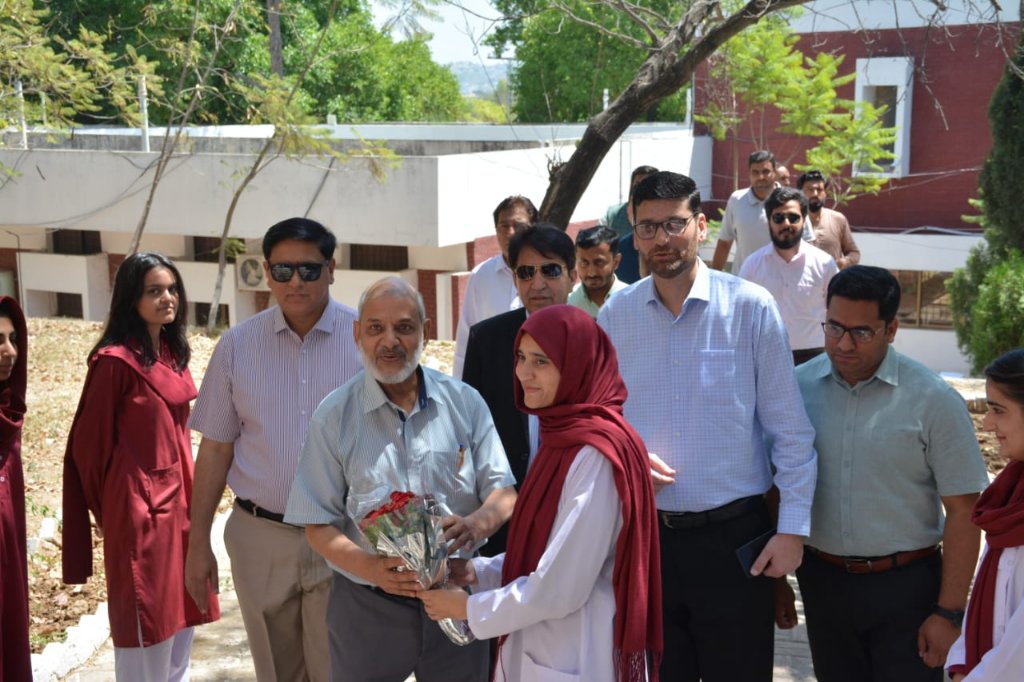 Welcoming guest with bouquet on campus