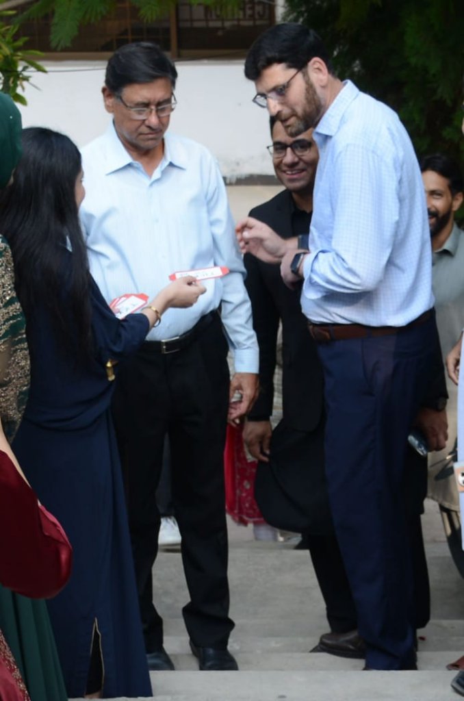 Faculty with students on campus steps