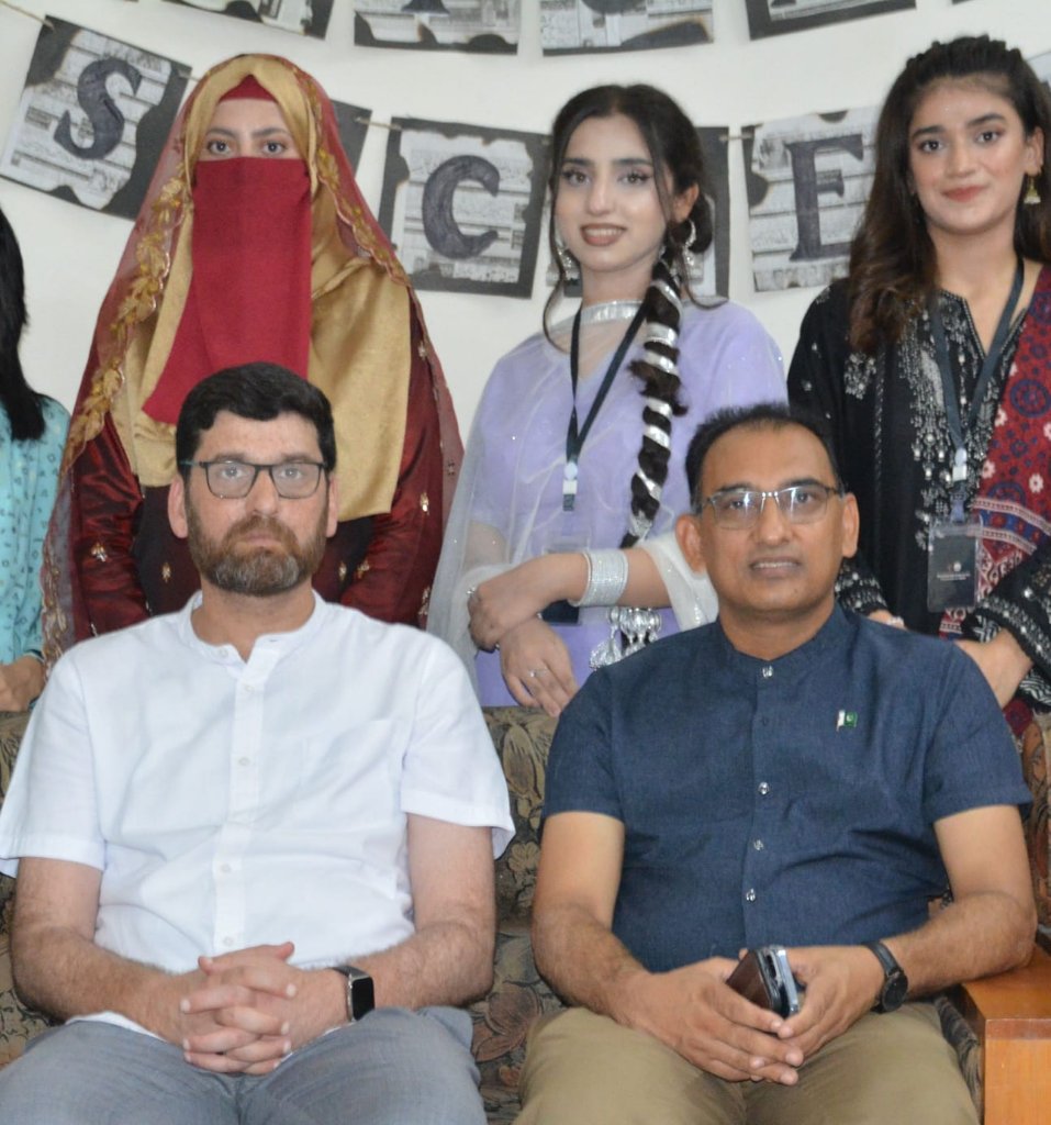 Faculty with students in cultural dress