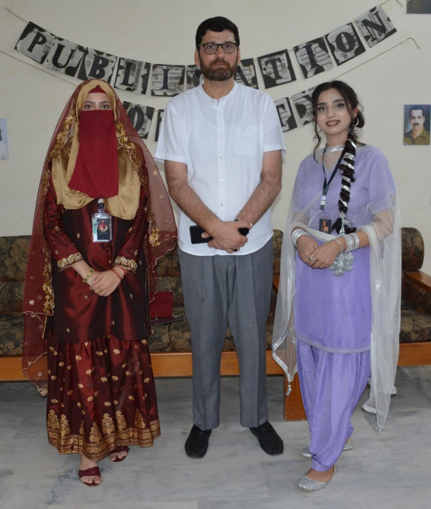 Students in traditional dress with faculty member