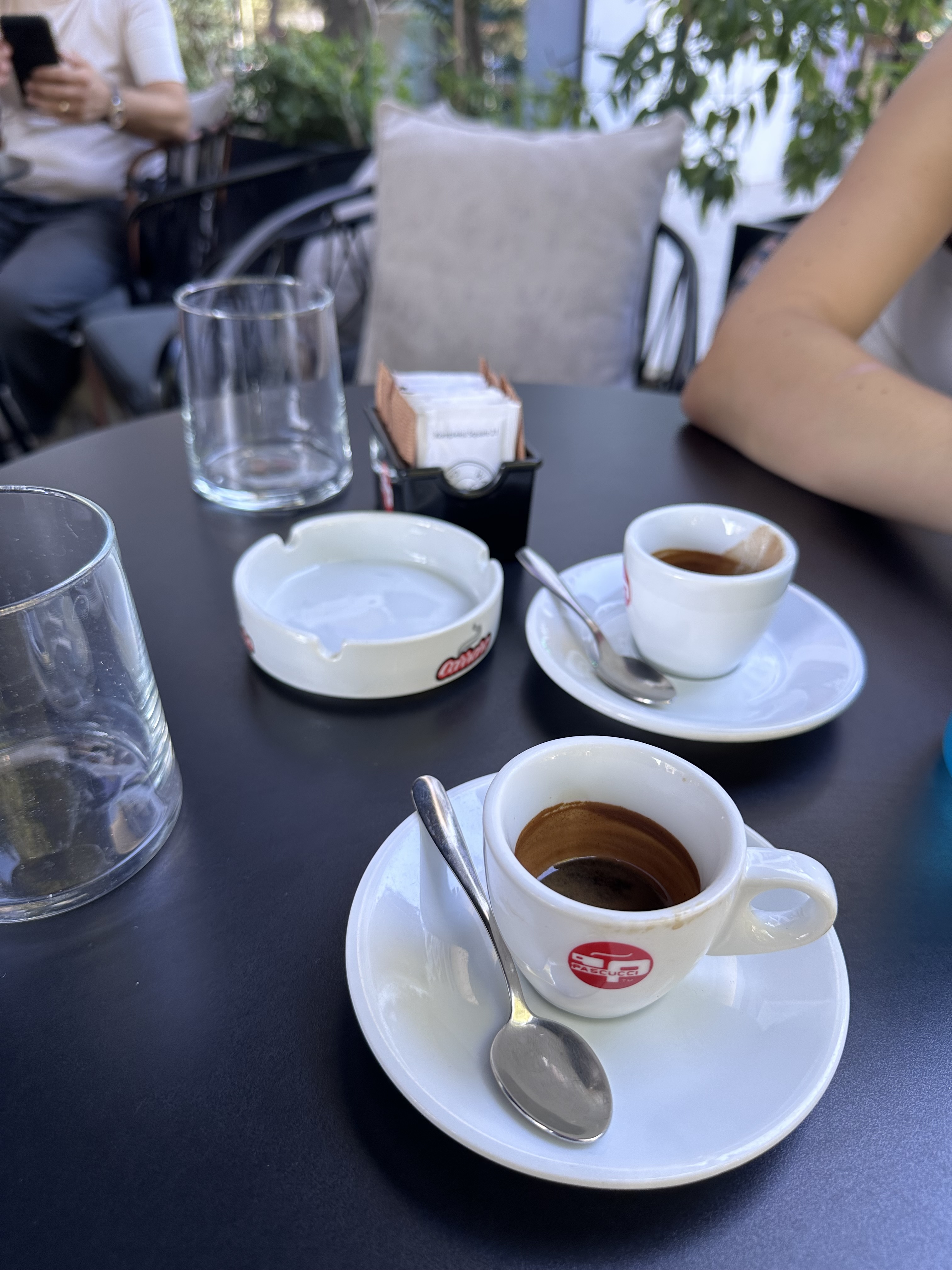 Espresso cups and water glasses on a table at Wake Up Coffee House