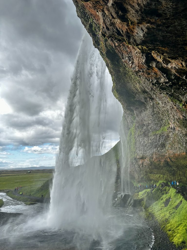 Seljalandsfoss waterfall in Iceland, cascading down a mossy cliff face