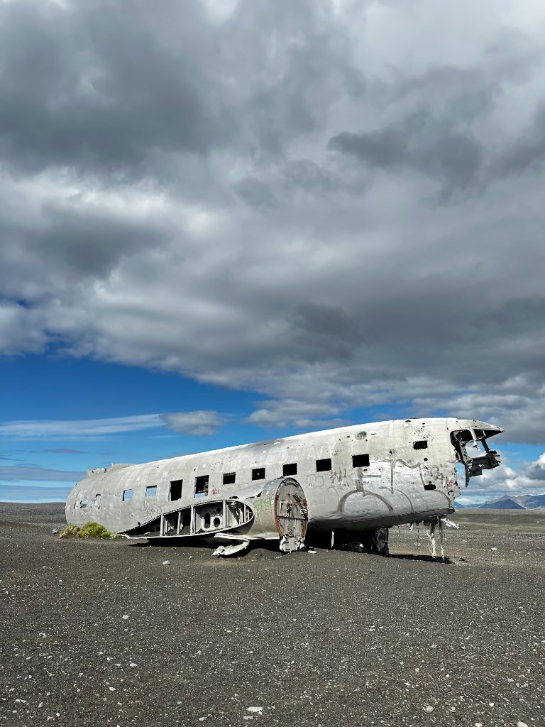 The Sólheimasandur plane wreck resting on a vast black sand plain in Iceland