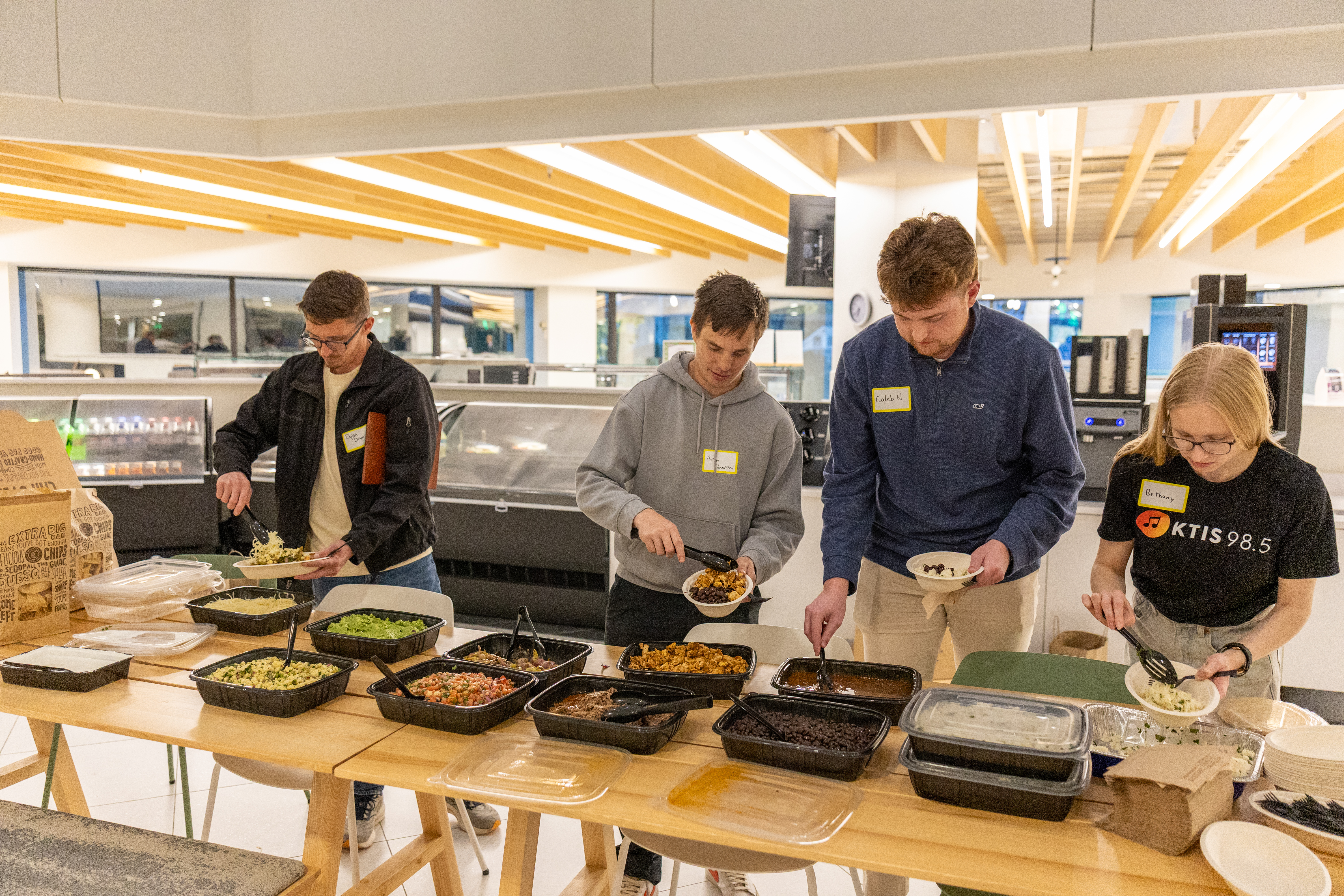 Volunteers serving dinner at a NEW event