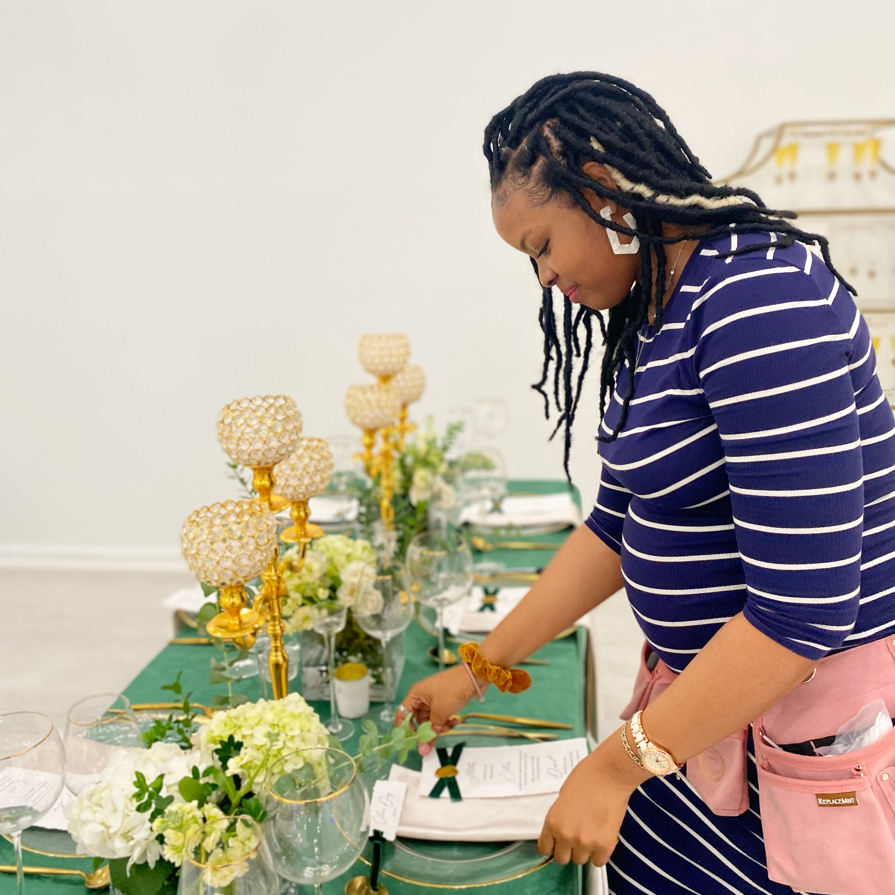 Behind the scenes, arranging an emerald and gold tablescape