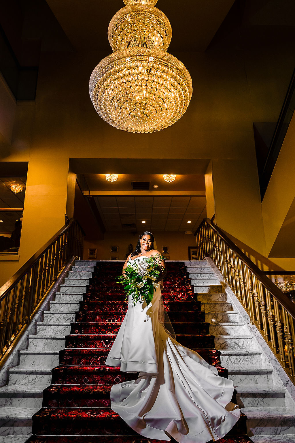 Bride and groom under a floral arch
