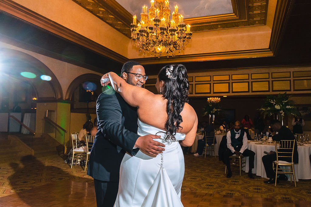 Newlyweds by the distillery barrels