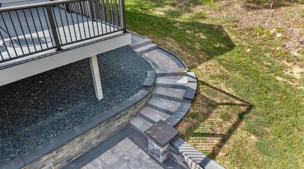 Custom curved stone staircase and patio by J&J Pro Build