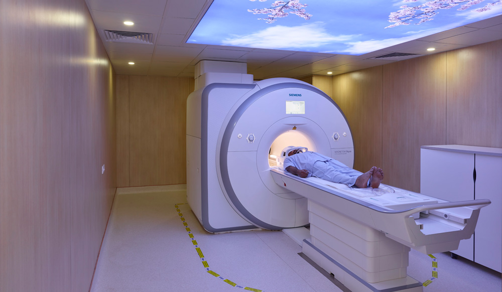 Meitra Hospital MRI suite with Siemens Magnetom scanner and nature-themed sky ceiling light panel.