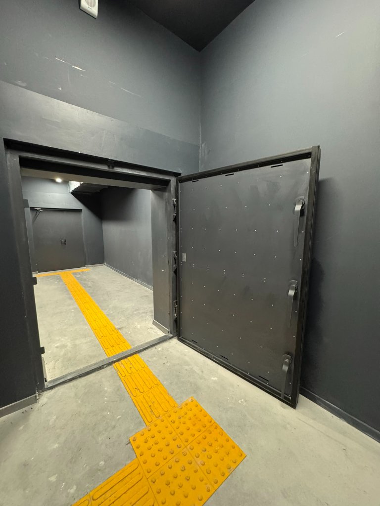 Black blast door closed in warehouse