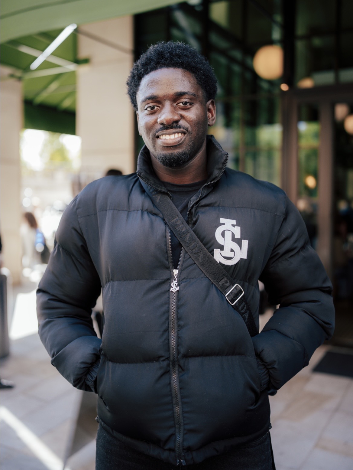 Brian Nnamdi, co-founder of Inside Excellence, wearing the brand's monogrammed puffer jacket