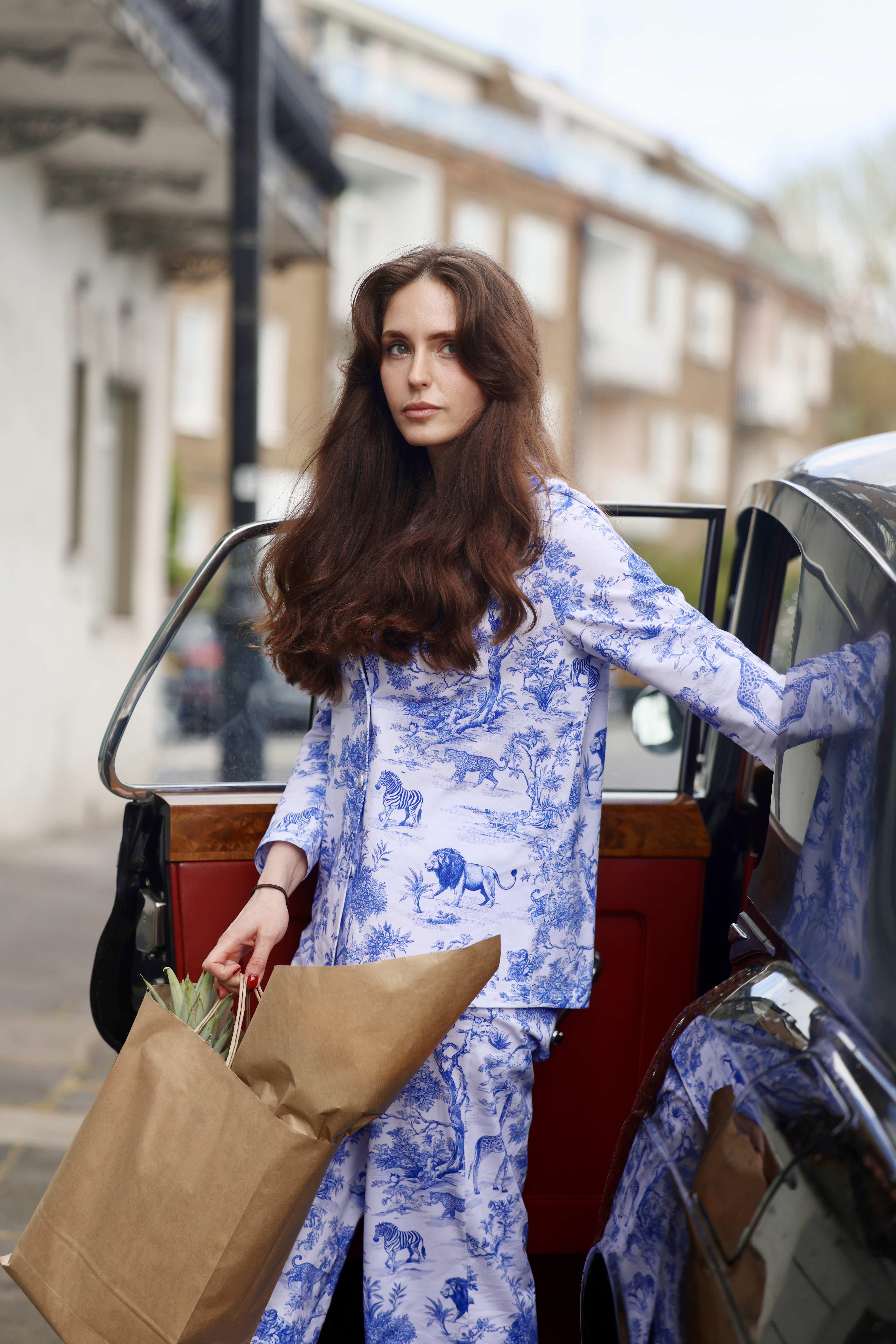 Natasha Hunt standing beside a vintage black car wearing NAKED WITHOUT pyjamas
