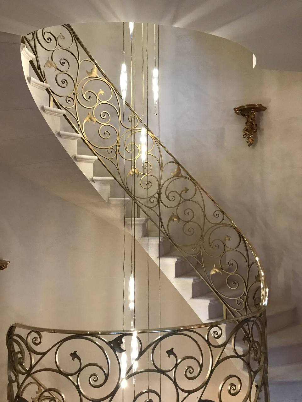 Gold balustrade full sweep — pendant lights descending