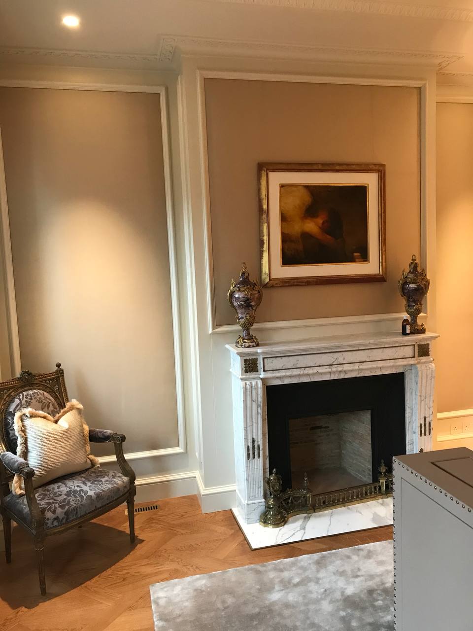 Master bedroom fireplace — herringbone parquet, gilded Louis XVI chair, marble surround