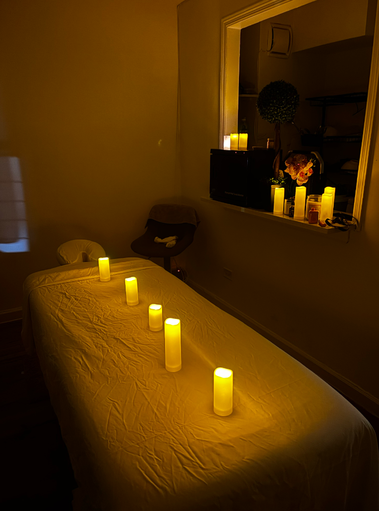 Ken Thai's massage studio — candlelit treatment bed