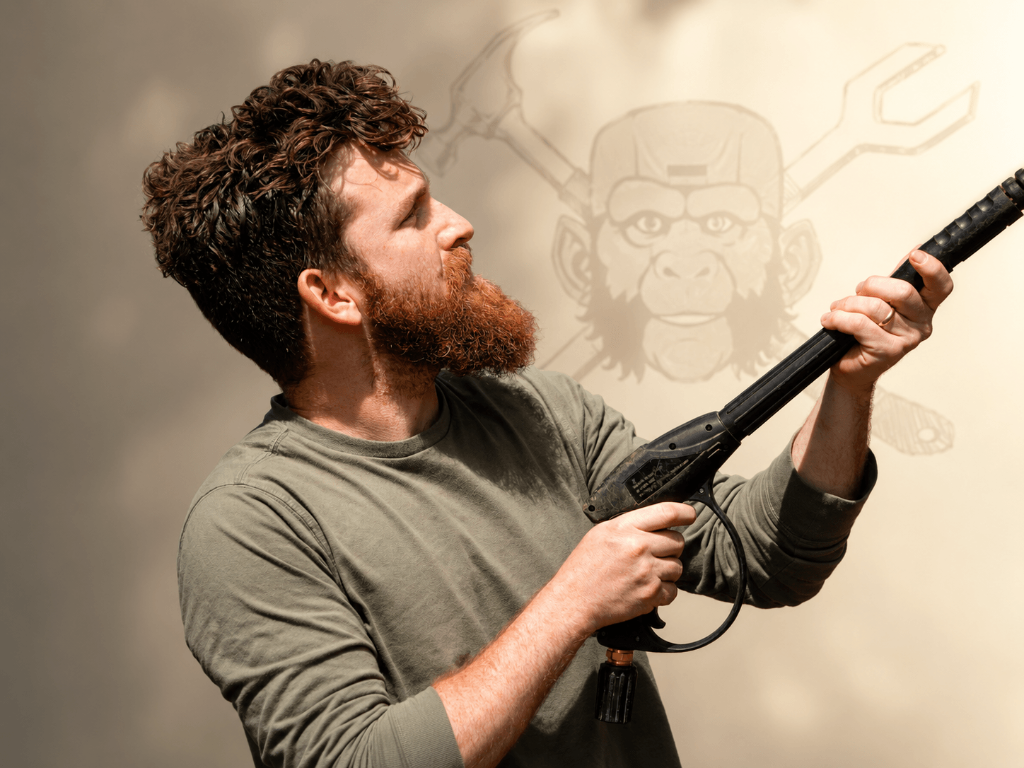 Ape Man Handyman owner holding a pressure washer