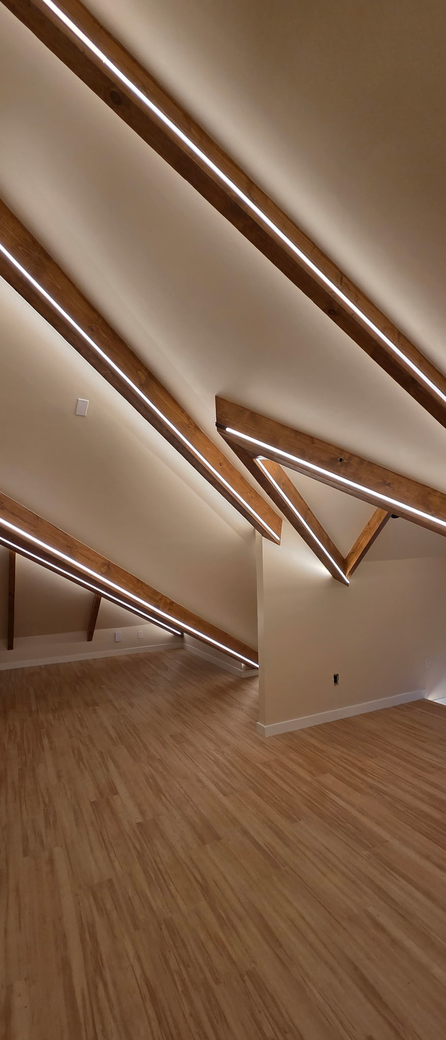Vaulted ceiling with exposed wooden beams and LED lighting