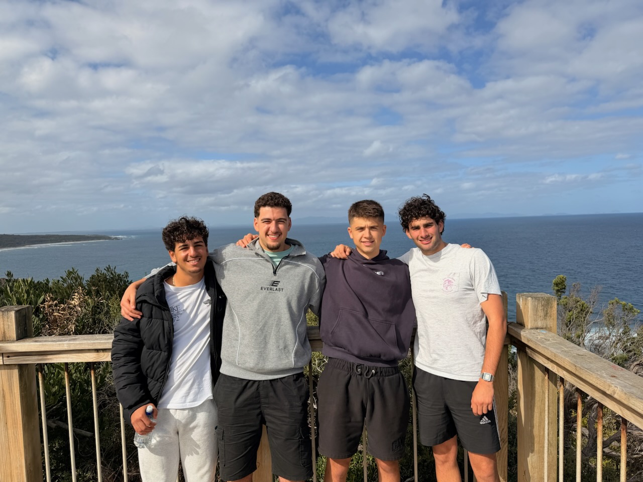 Four young men at the coast