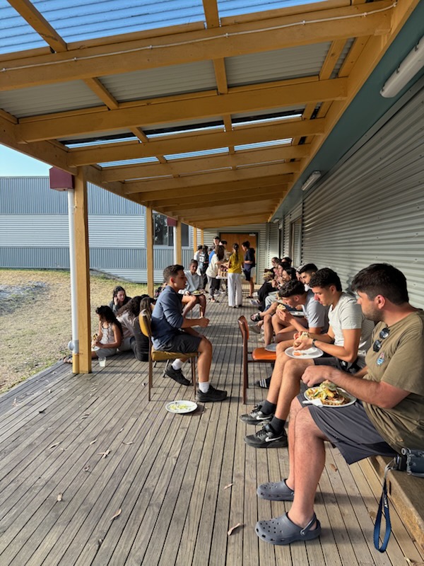 Youth group sharing a meal on the deck