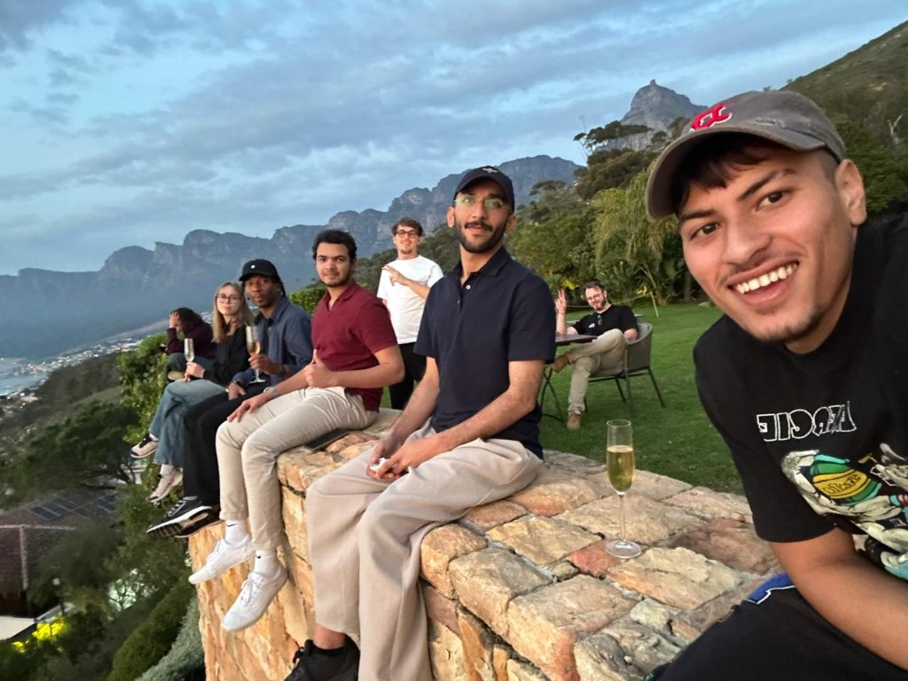Guests gathered on a stone wall at twilight