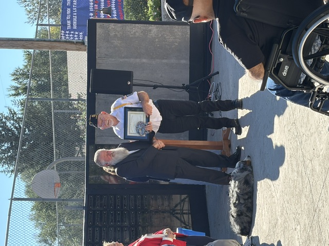 Avondale Veteran's Parade — veteran receiving framed certificate at podium