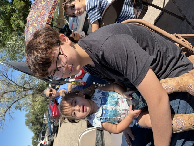 Avondale Veteran's Parade — child with fringe vest on lap
