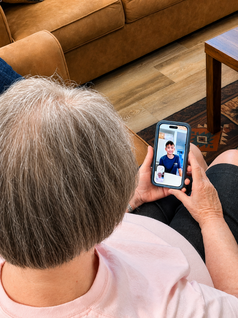 A senior learning to video call with family