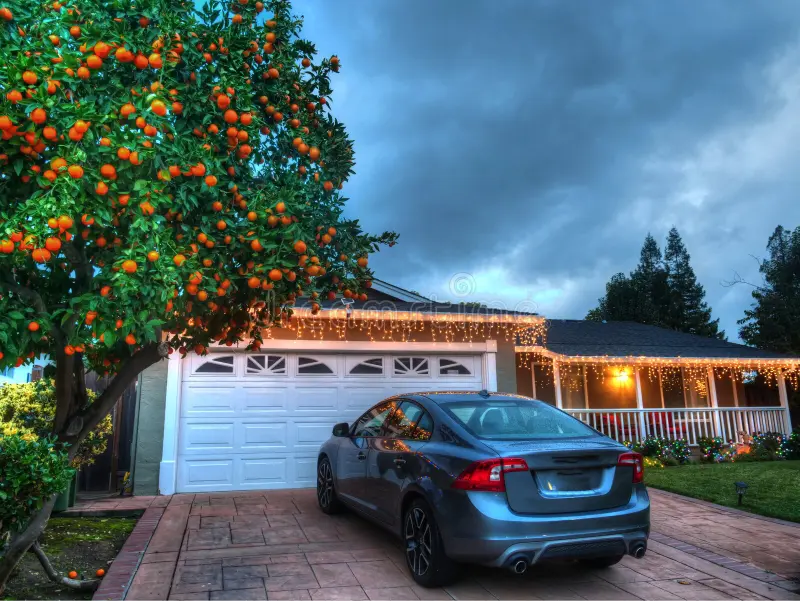 Car parked in residential driveway at dusk