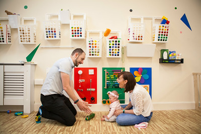 Parents and baby playing together at the Sonas community space