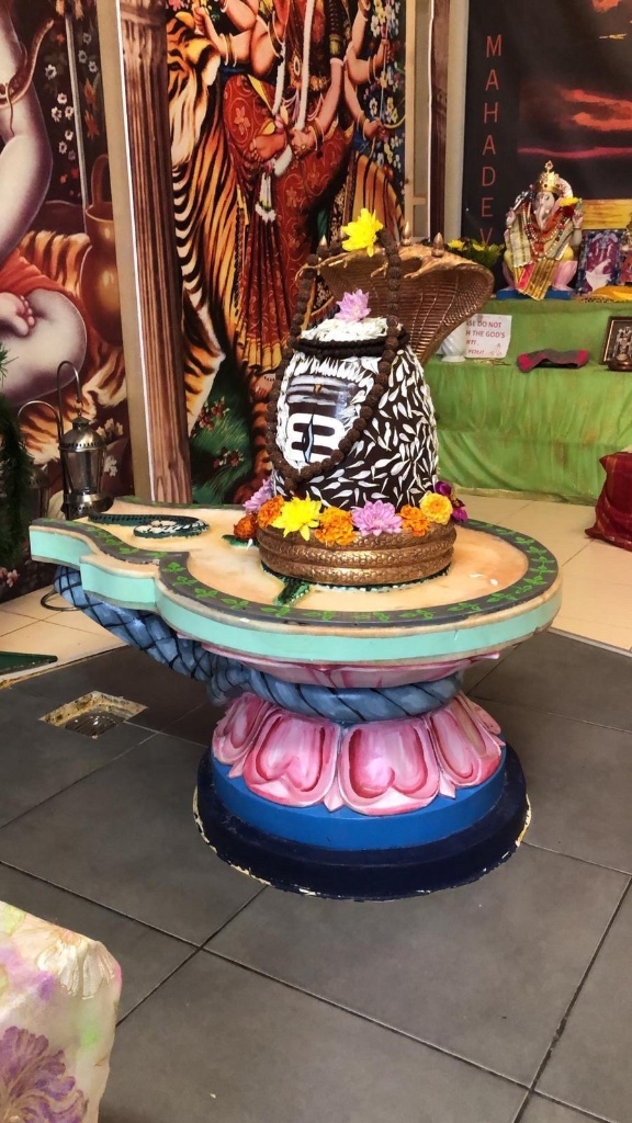 A striking patterned shringar with marigold and lotus offerings.